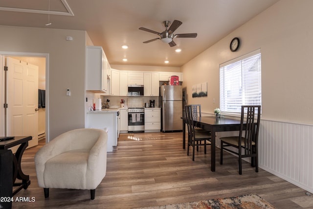 kitchen with ceiling fan, white cabinetry, stainless steel appliances, and dark wood-type flooring