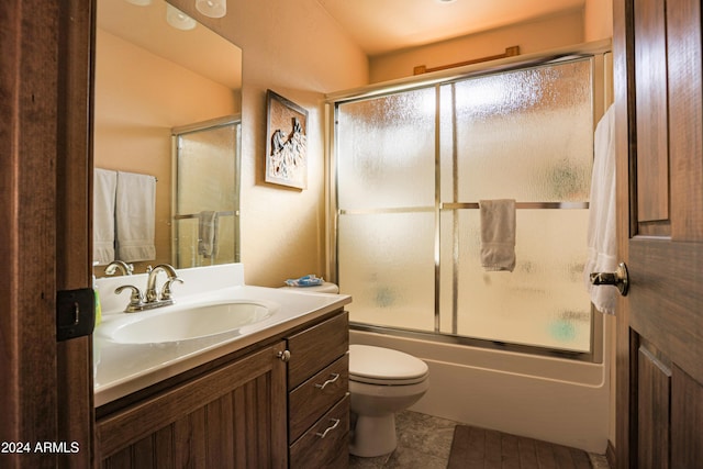 full bathroom featuring toilet, vanity, tile patterned floors, and enclosed tub / shower combo