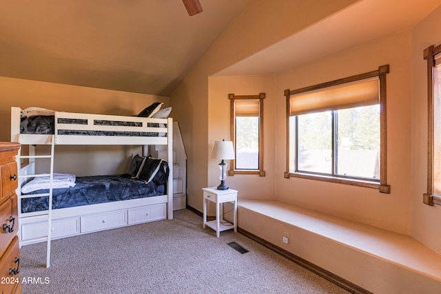 bedroom with carpet flooring, ceiling fan, and vaulted ceiling