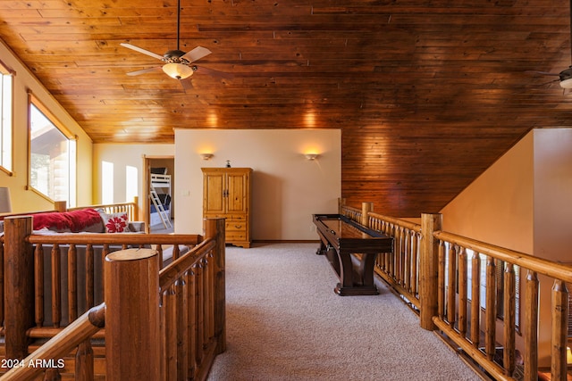 corridor featuring carpet, lofted ceiling, and wooden ceiling