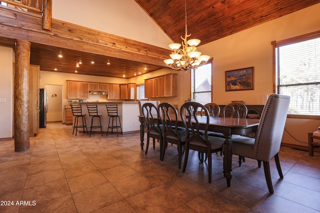 tiled dining area featuring high vaulted ceiling, an inviting chandelier, and wood ceiling