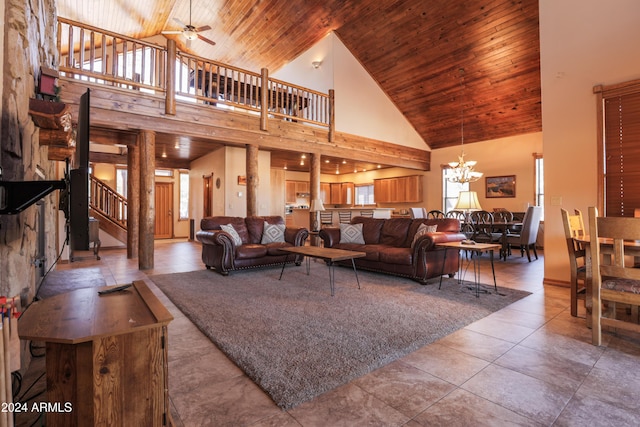 tiled living room with ceiling fan with notable chandelier, high vaulted ceiling, and wooden ceiling