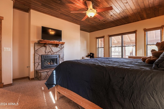 bedroom with a fireplace, light colored carpet, ceiling fan, and wooden ceiling