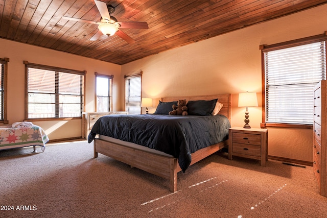 bedroom featuring carpet, ceiling fan, and wooden ceiling