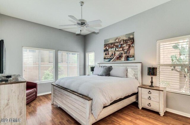 8245 E Bell Rd Unit 103, Scottsdale, AZ 85260 - bedroom featuring baseboards, wood finished floors, and a ceiling fan