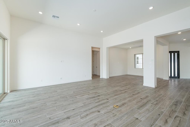 9775 S 36th Ln, Laveen, AZ 85339 - unfurnished living room with light wood-type flooring, recessed lighting, and baseboards