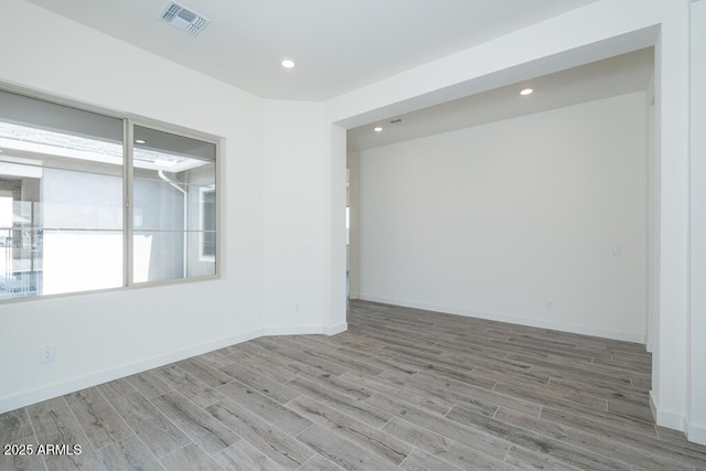 9775 S 36th Ln, Laveen, AZ 85339 - unfurnished room with wood finished floors, baseboards, and recessed lighting