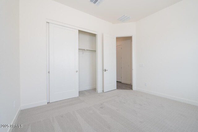 9775 S 36th Ln, Laveen, AZ 85339 - unfurnished bedroom featuring a closet, light carpet, and baseboards