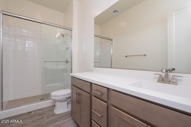 9775 S 36th Ln, Laveen, AZ 85339 - bathroom with toilet, a shower stall, vanity, and wood finished floors