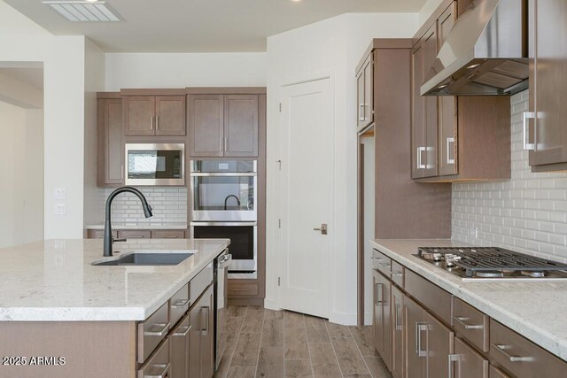 9775 S 36th Ln, Laveen, AZ 85339 - kitchen with a sink, appliances with stainless steel finishes, exhaust hood, and tasteful backsplash