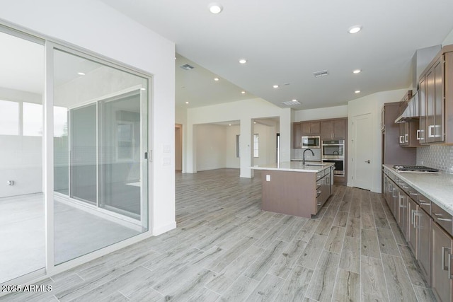 9775 S 36th Ln, Laveen, AZ 85339 - kitchen with a sink, light wood-style floors, a center island with sink, light countertops, and recessed lighting
