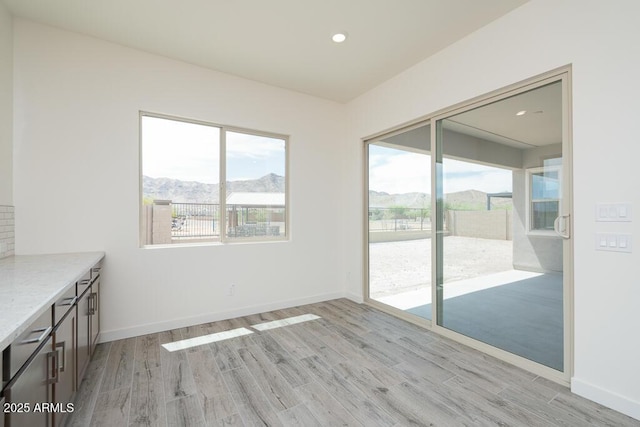 9775 S 36th Ln, Laveen, AZ 85339 - unfurnished room featuring light wood-style floors, a mountain view, baseboards, and recessed lighting