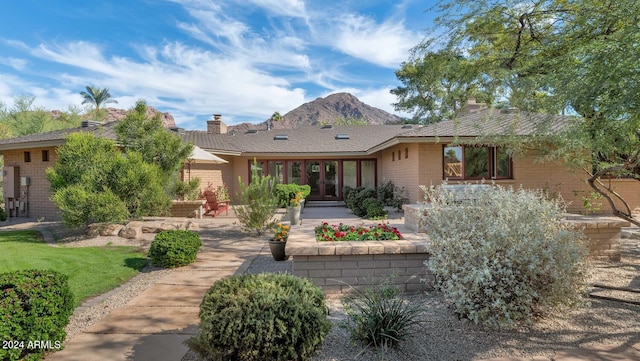 rear view of property featuring a mountain view