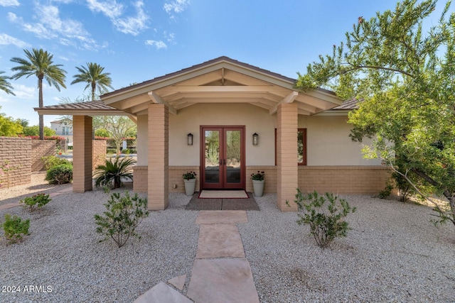 view of exterior entry featuring french doors