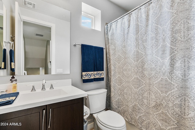 bathroom with toilet, visible vents, and vanity