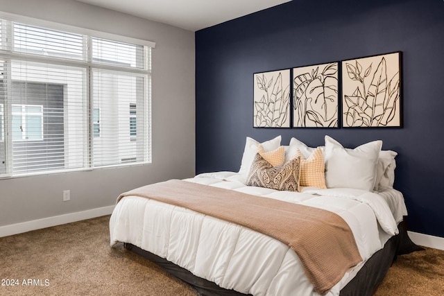 carpeted bedroom featuring baseboards