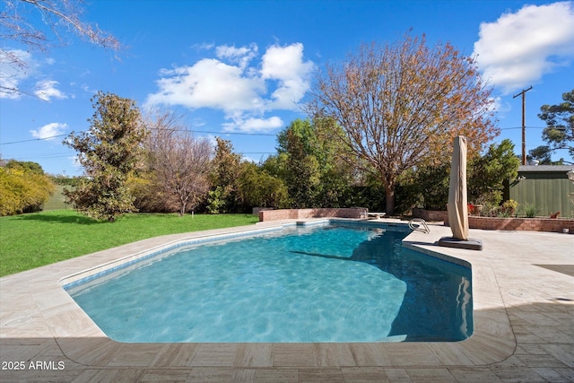 view of pool featuring a yard and a patio area