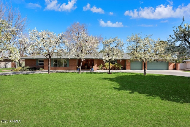 single story home with a garage and a front yard