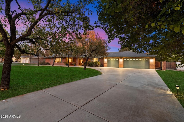 view of front of property with a yard and a garage