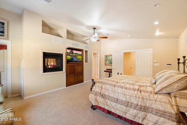 carpeted bedroom with ceiling fan and vaulted ceiling