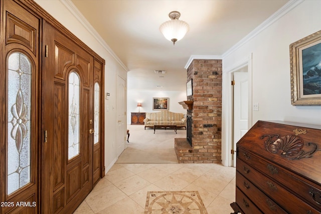 tiled foyer entrance featuring ornamental molding