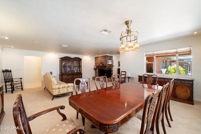 carpeted dining space with ornamental molding and a fireplace