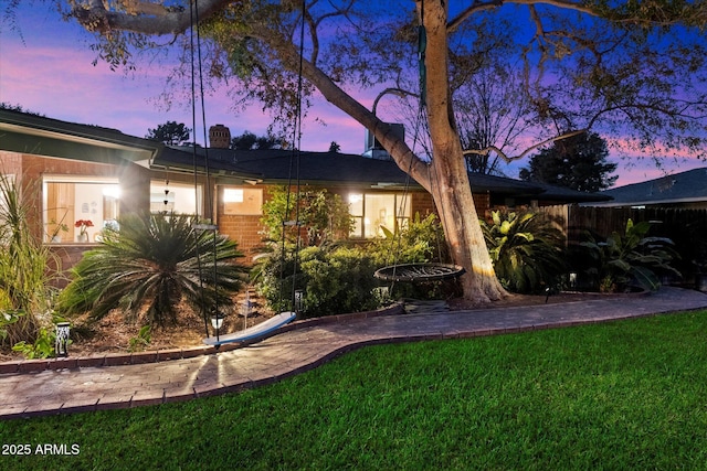 ranch-style house featuring a lawn