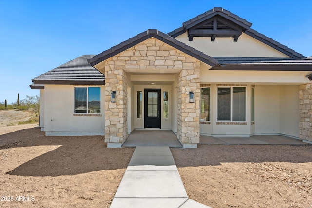 view of front of property with a tiled roof and stucco siding