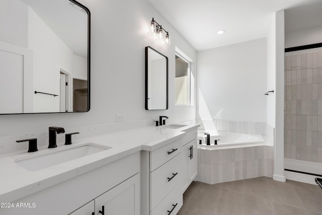 full bathroom featuring double vanity, a sink, a bath, and tile patterned floors