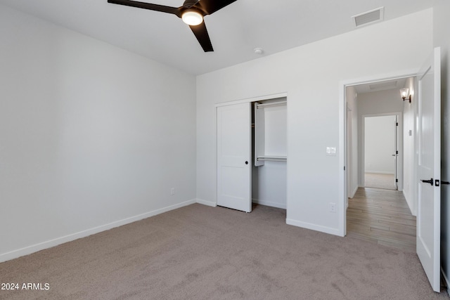 unfurnished bedroom with baseboards, visible vents, a ceiling fan, carpet floors, and a closet