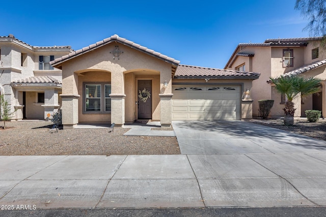 6328 W Fawn Dr, Laveen, AZ 85339 - mediterranean / spanish-style home featuring a tiled roof, a garage, stucco siding, and driveway