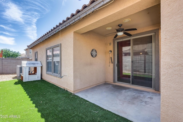 6328 W Fawn Dr, Laveen, AZ 85339 - entrance to property with ceiling fan, a patio area, fence, a yard, and stucco siding