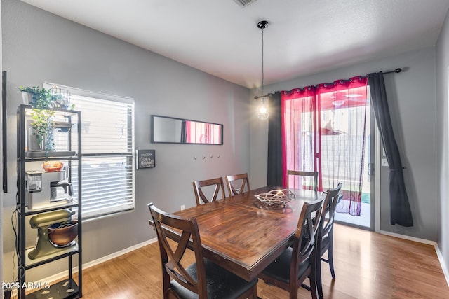6328 W Fawn Dr, Laveen, AZ 85339 - dining space featuring baseboards, light wood-style flooring, and a healthy amount of sunlight