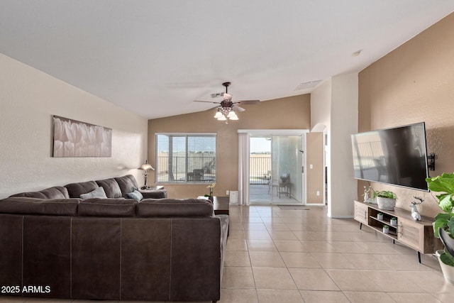 living area featuring a ceiling fan, lofted ceiling, visible vents, and light tile patterned floors