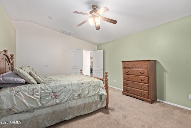 bedroom with visible vents, vaulted ceiling, light carpet, and baseboards