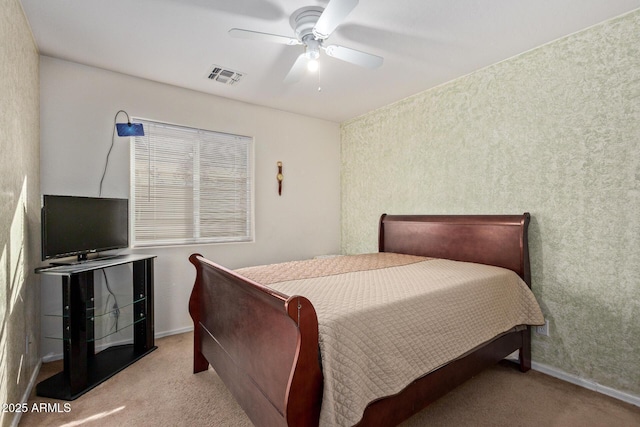 bedroom with baseboards, a ceiling fan, visible vents, and light colored carpet