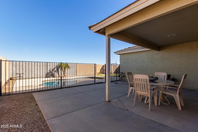 view of patio / terrace with fence and a fenced in pool