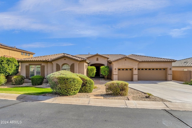 mediterranean / spanish-style home with a garage