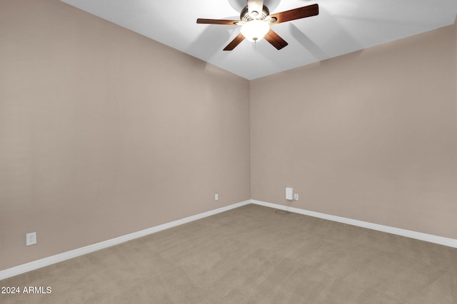 carpeted spare room with ceiling fan