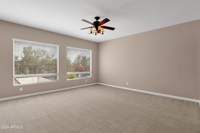 unfurnished room with ceiling fan and light colored carpet