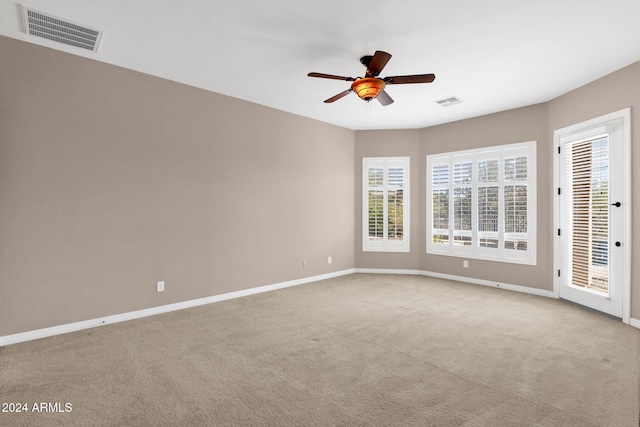 unfurnished room featuring ceiling fan and light carpet