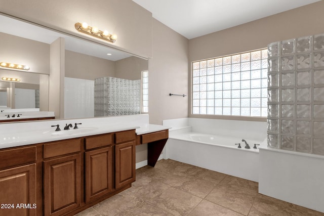 bathroom featuring tile patterned flooring, a washtub, and vanity