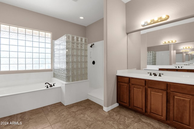 bathroom featuring vanity and shower with separate bathtub