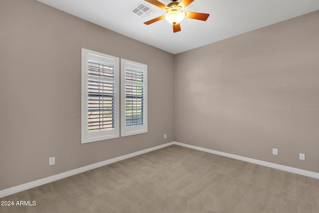 spare room with light carpet and ceiling fan