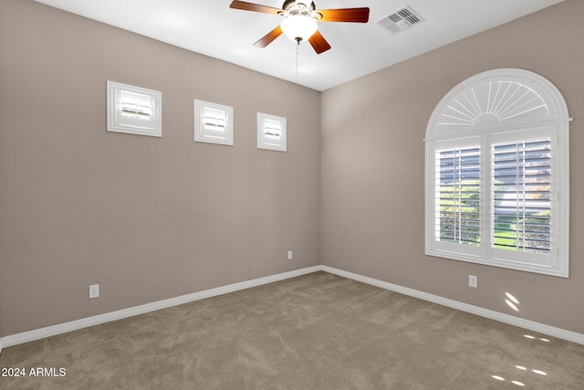 carpeted spare room with ceiling fan