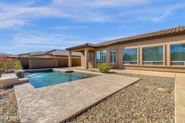 view of swimming pool featuring pool water feature and a patio