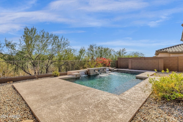 view of swimming pool featuring pool water feature and a patio