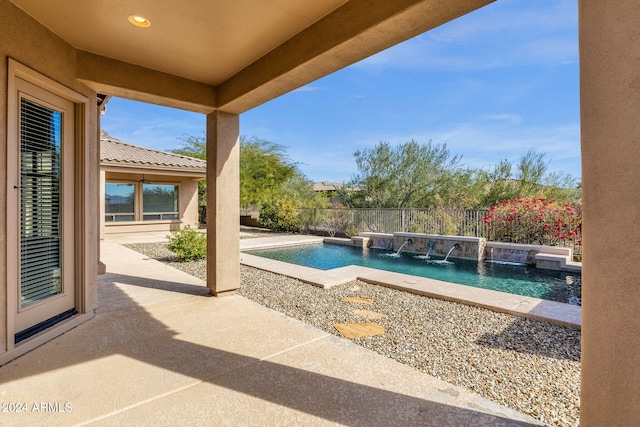 view of pool with a patio area and pool water feature