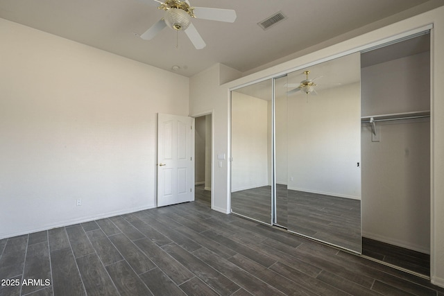 unfurnished bedroom with wood tiled floor, visible vents, a closet, and a ceiling fan