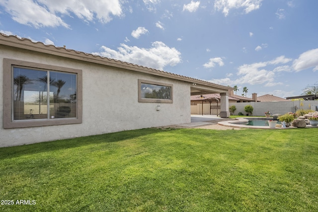 back of property with a patio, a fenced in pool, a fenced backyard, stucco siding, and a yard
